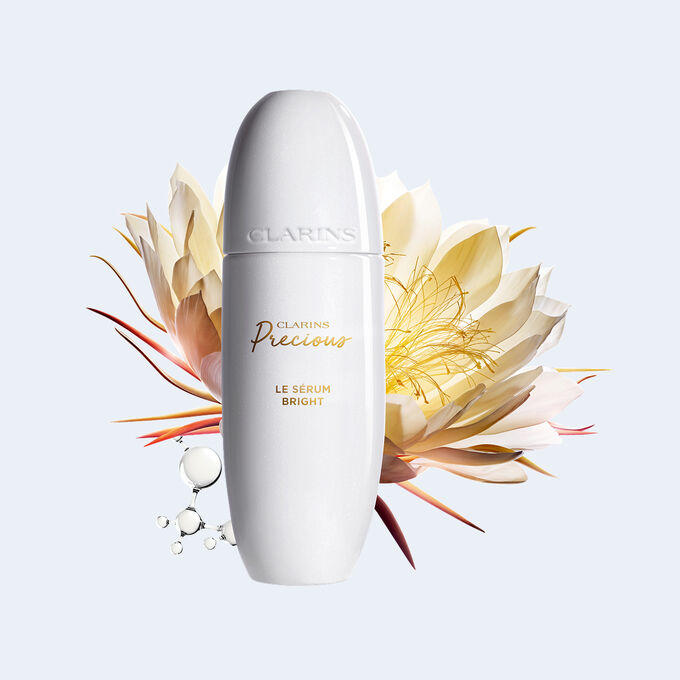 Packshot des Clarins Precious Bright Serums, umgeben von Mondlichtblumen und Peptidmolek&uuml;len, die die wichtigsten Wirkstoffe f&uuml;r Anti-Aging veranschaulichen.